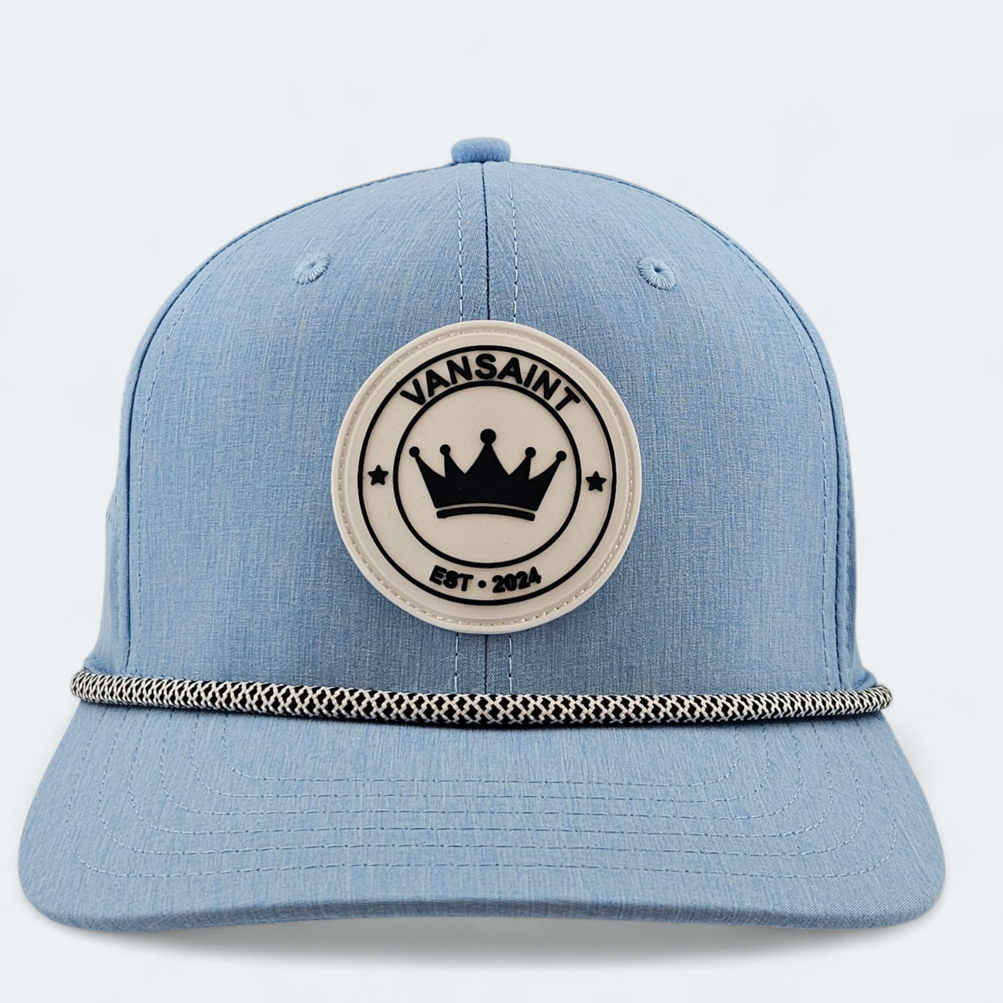 Blue cap with a circular rubber patch logo featuring 'Vansaint' on a light gray background