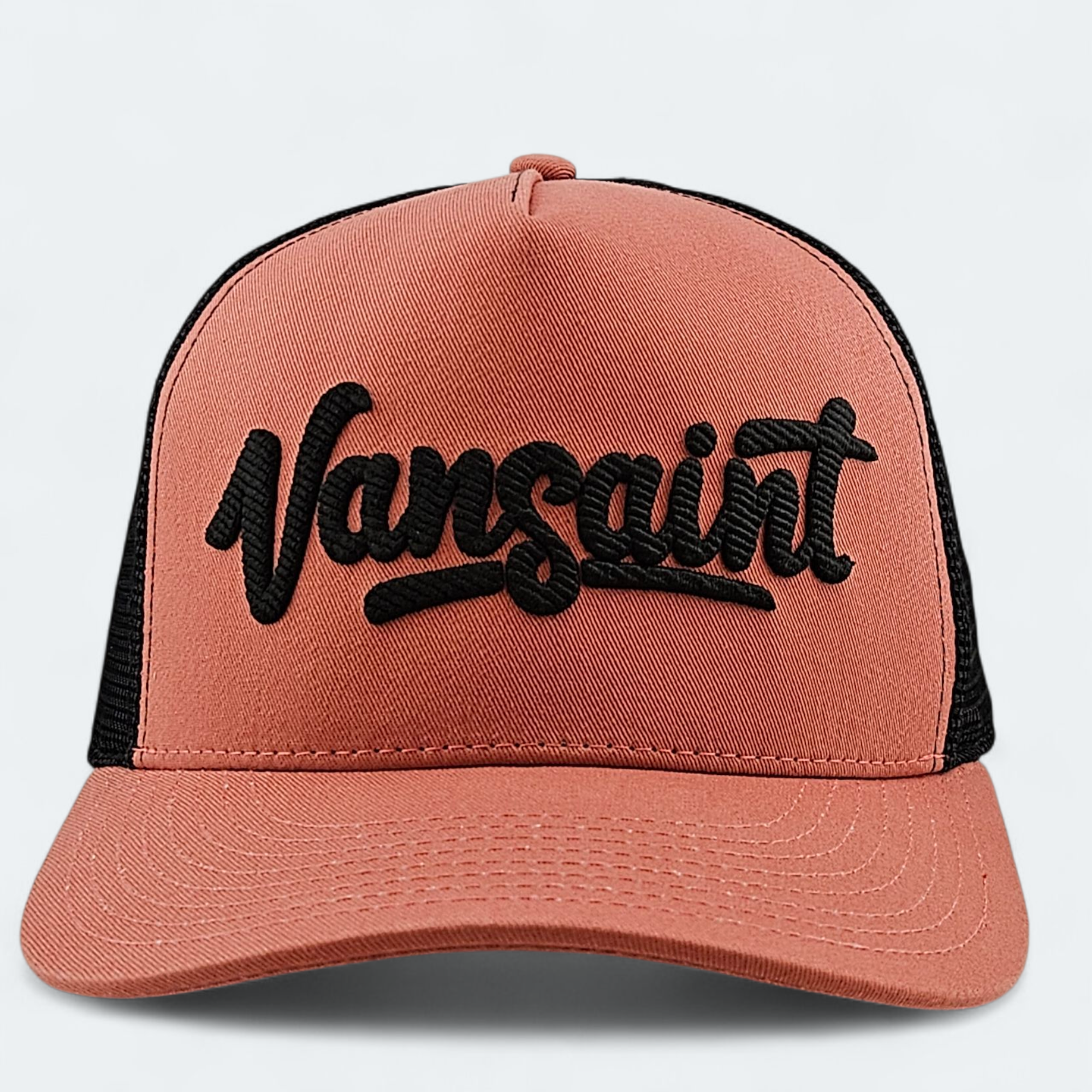 Pink cap with black mesh and 'Vansaint' logo on a light gray background